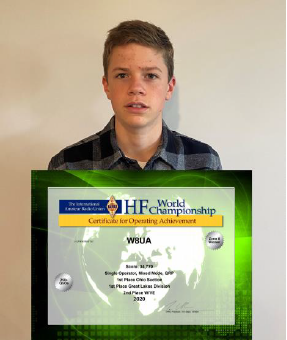 Java Miller holding an HF World Championship certificate.